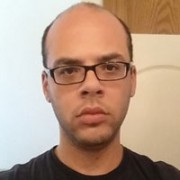 Unsmiling balding man with glasses